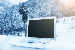 The right backup disaster recovery solution this winter season shown with a laptop in the snow after a blizzard 