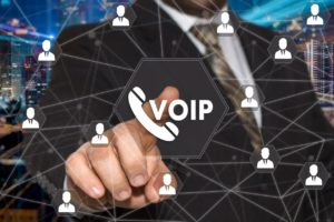 The businessman chooses VOIP button on the touch screen with a futuristic background .The concept VOIP