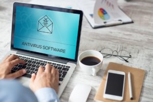 Business man downloading an anti-malware program or antivirus software