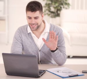 Man woking remotely from home, web conferencing with VoIP systems 