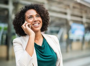 Business woman using VOIP in a mobile phone out outdoors 