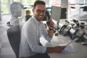 business man speed testing his VoIP service. Business man in office. Looking at camera 