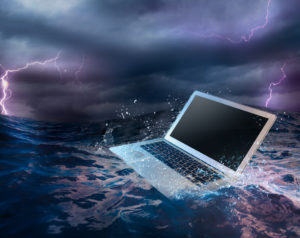 Backup Disaster Recovery (BDR) Plan concept with laptop on water