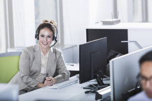 Woman in office cubicle using a Managed Service Provider (MSP) for business protection 