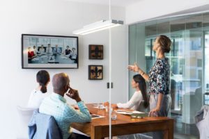 Business people in an office using VOIP to have a confrence call meeting. 