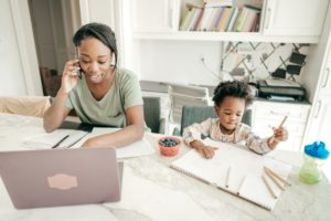 Multitasking mom working from home with the employment perks of offering integrating VOIP phones 