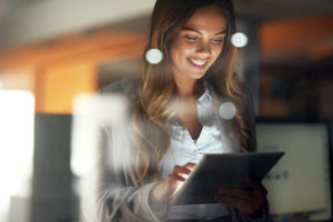 Shot of a young attractive businesswoman working late at night in a modern office