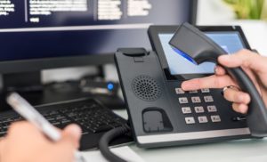 VOIP customer support concept, showing person using VOIP headset and computer. 