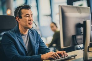 Male IT professional working with a company's IT infrastructure and data security using a computer. 