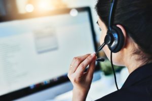 Female IT help desk provider speaking with a customer. 