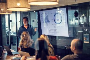 Businessman giving a presentation of monthly business reports during a meeting. 