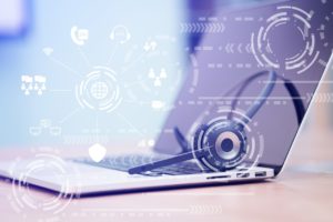 A laptop and a wireless headset showing VoIP system operation concept