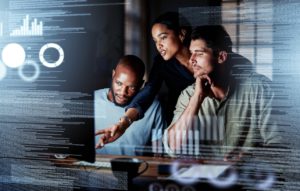 Team of IT professionals in an office working on a computer - using Office 365's full potential. 