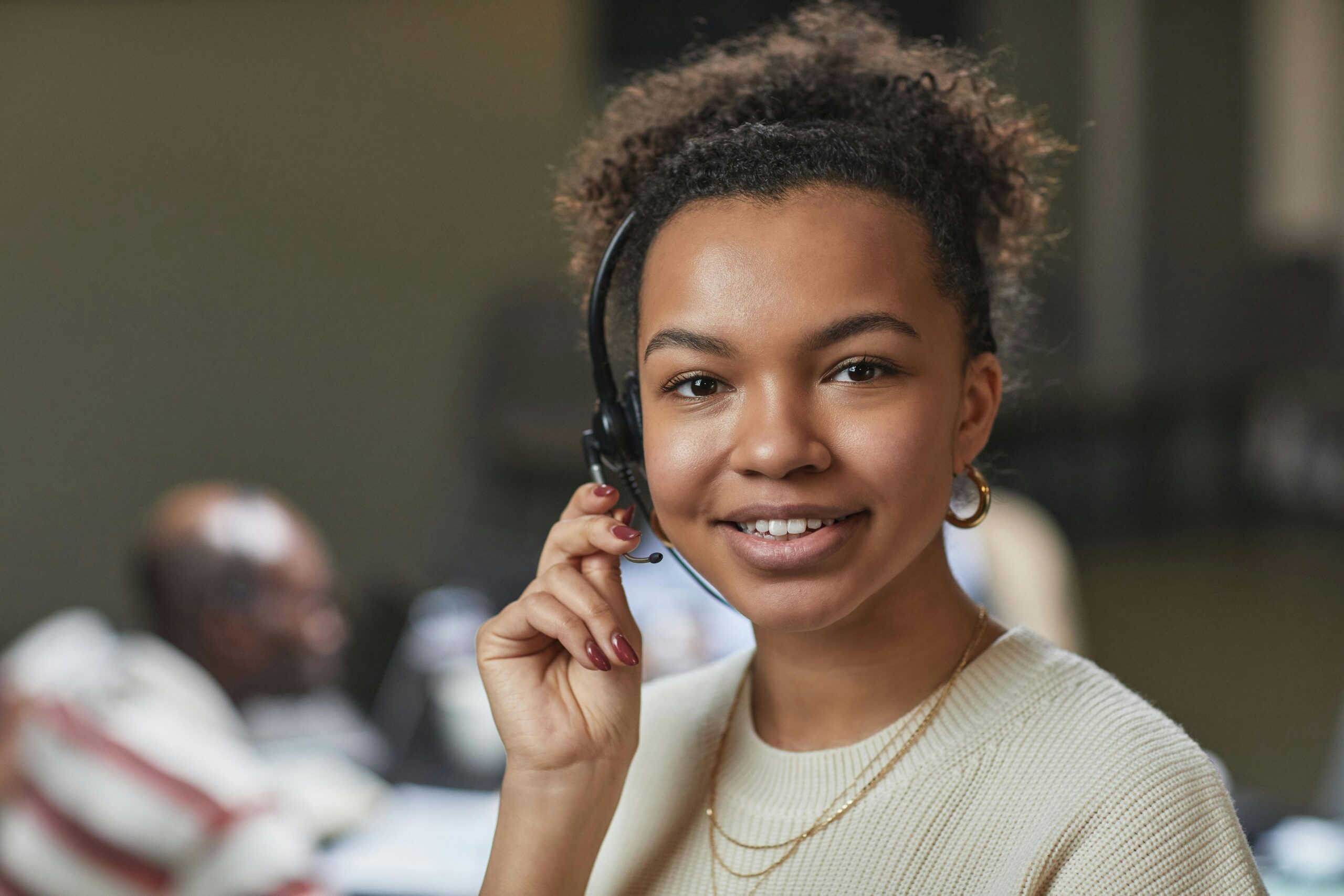 Smiling IT support specialist wearing headset.